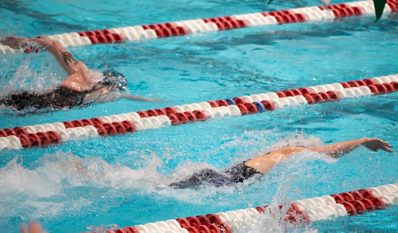 CAMBRIDGE, MA - FEBRUARY 19: University of Pennsylvania swimmer Lia Thomas (R) swims against Yale University swimmer Iszac Henig (L) during the 100 yard freestyle during the 2022 Ivy League Womens Swimming and Diving Championships at Blodgett Pool on February 19, 2022 in Cambridge, Massachusetts. (Photo by Kathryn Riley/Getty Images)