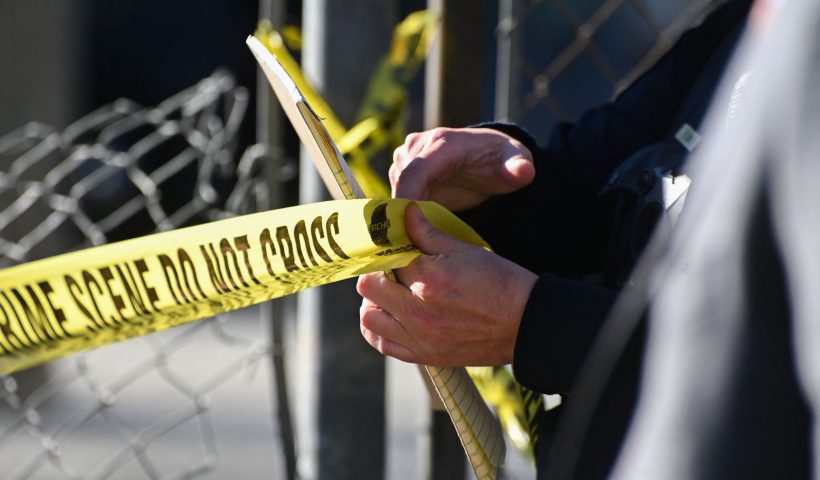 US-CRIME-SHOOTING A San Mateo County Sheriff officer puts up police tape at a crime scene after a shooting at the Spanish Town shops in Half Moon Bay, California, on January 24, 2023. - A suspected gunman was in custody Monday over the killing of seven people in a rural community in northern California, just two days after a mass shooting at a Lunar New Year celebration near Los Angeles. (Photo by Samantha Laurey / AFP) (Photo by SAMANTHA LAUREY/AFP via Getty Images)