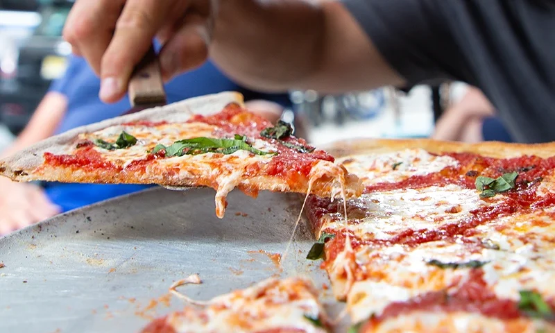 NEW YORK, NEW YORK - JULY 07: A Margherita pie is seen served at the famous Lombardi's Pizza amid the COVID-19 pandemic on July 07, 2020 in New York, New York. In 1905, Lombardi's Pizza was recognized as the First Pizzeria in the United States. Amid the coronavirus pandemic, Lombardi's has reopened its doors once again. (Photo by Arturo Holmes/Getty Images)