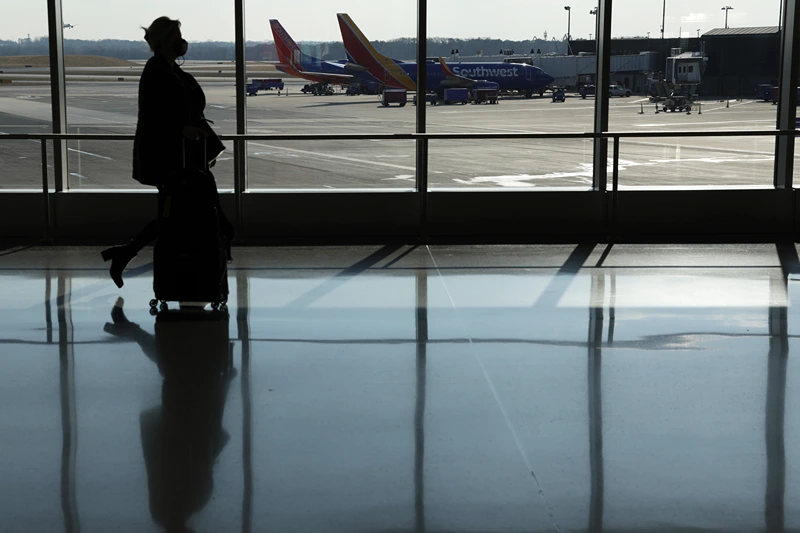 Holiday Travel Expected To Rise Over 25 Percent Over 2020 Despite COVID-19 Uptick
BALTIMORE, MARYLAND - DECEMBER 22: A passenger walks through a terminal at Baltimore/Washington International Thurgood Marshall Airport (BWI) on December 22, 2021 in Baltimore, Maryland. AAA predicted more than 109 million Americans will travel 50 miles or more over Christmas and New Year holidays, a spike of 27.7% over last year. (Photo by Alex Wong/Getty Images)