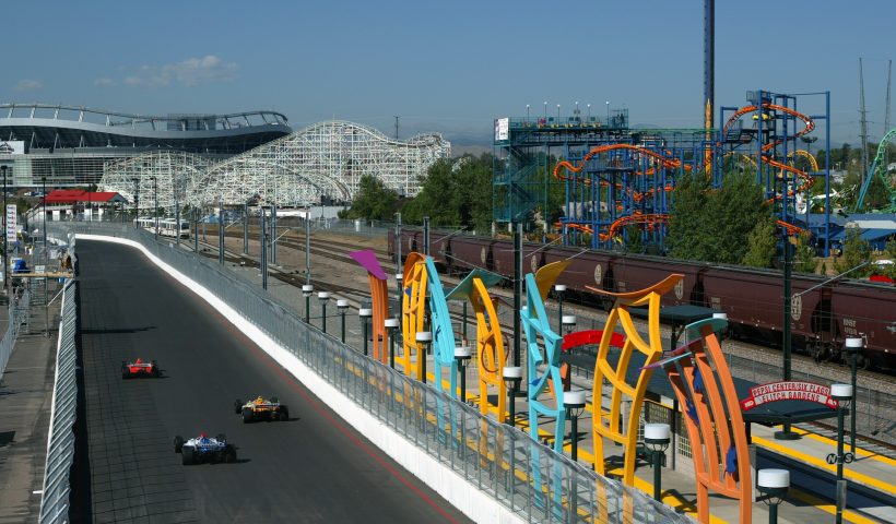 DENVER, CO - AUGUST 30: Team Motorola driver Michael Andretti drives his Honda Lola in front of a train stop and the Six Flags Elitch Gardens amusement park during practice for the Shell Grand Prix of Denver, round 14 of the CART (Championship Auto Racing Teams) Fed Ex Championship Series in Denver, Colorado. (Photo by Robert Laberge/Getty Images).