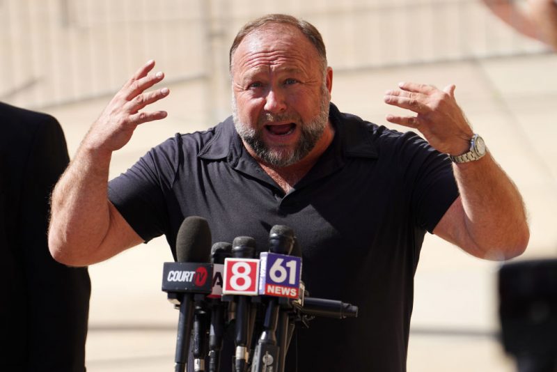 WATERBURY, CONNECTICUT - SEPTEMBER 21: InfoWars founder Alex Jones speaks to the media outside Waterbury Superior Court during his trial on September 21, 2022 in Waterbury, Connecticut. Jones is being sued by several victims' families for causing emotional and psychological harm after they lost their children in the Sandy Hook massacre. A Texas jury last month ordered Jones to pay $49.3 million to the parents of 6-year-old Jesse Lewis, one of 26 students and teachers killed in the shooting in Newtown, Connecticut. (Photo by Joe Buglewicz/Getty Images)