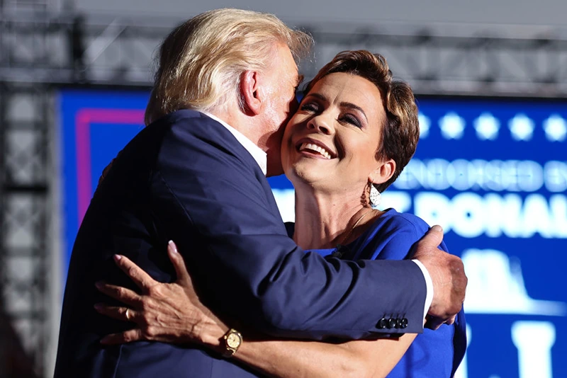 Donald Trump Holds Campaign Rally In Support Of Arizona GOP Candidates
MESA, ARIZONA - OCTOBER 09: Former U.S. President Donald Trump embraces Arizona Republican gubernatorial nominee Kari Lake at a campaign rally at Legacy Sports USA on October 09, 2022 in Mesa, Arizona. Trump was stumping for Arizona GOP candidates ahead of the midterm election on November 8. (Photo by Mario Tama/Getty Images)