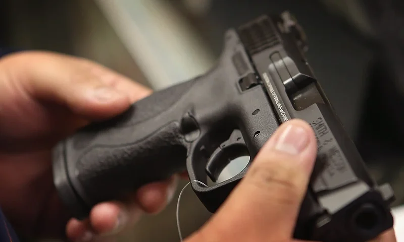 TINLEY PARK, IL - DECEMBER 17: A customer shops for a pistol at Freddie Bear Sports sporting goods store on December 17, 2012 in Tinley Park, Illinois. Americans purchased a record number of guns in 2012 and gun makers have reported a record high in demand. Firearm sales have surged recently as speculation of stricter gun laws and a re-instatement of the assault weapons ban following the mass school shooting in Connecticut . (Photo by Scott Olson/Getty Images)