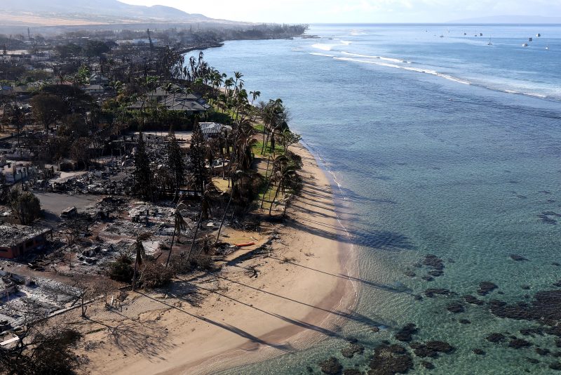 LAHAINA, HAWAII - AUGUST 11: In an aerial view, homes and businesses are seen that were destroyed by a wildfire on August 11, 2023 in Lahaina, Hawaii. Dozens of people were killed and thousands were displaced after a wind-driven wildfire devastated the town of Lahaina on Tuesday. Crews are continuing to search for missing people. (Photo by Justin Sullivan/Getty Images)