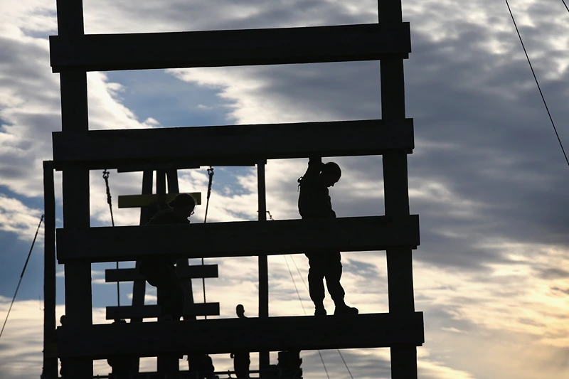 CAMP LEJEUNE, NC - FEBRUARY 20: A female Marine climbs the Stairway to Heaven obstacle on the Confidence Course during Marine Combat Training (MCT) on February 20, 2013 at Camp Lejeune, North Carolina. Since 1988 all non-infantry enlisted male Marines have been required to complete 29 days of basic combat skills training at MCT after graduating from boot camp. MCT has been required for all enlisted female Marines since 1997. About six percent of enlisted Marines are female. (Photo by Scott Olson/Getty Images)