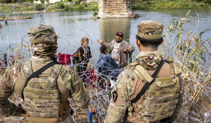 Surge In Migration Overwhelms Texas Border City Of Eagle Pass EAGLE PASS, TEXAS - SEPTEMBER 27: Venezuelan immigrant Louis Sanchez asks Texas National Guard troops to let his family pass through razor wire after they crossed the Rio Grande from Mexico on September 27, 2023 in Eagle Pass, Texas. A surge of migrants crossing the U.S. southern border seeking asylum has put pressure on U.S. immigration authorities, reaching record levels during the last week. (Photo by John Moore/Getty Images)
