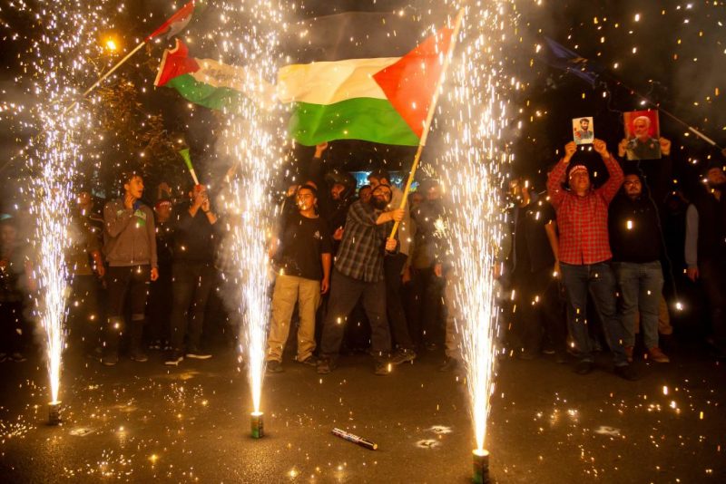 10/07/2023 Tehran, Iran. Iranian pro-government supporters celebrate the Hamas attack on Israel with fireworks and by waving a Palestinian flag in Palestine Square in Tehran.