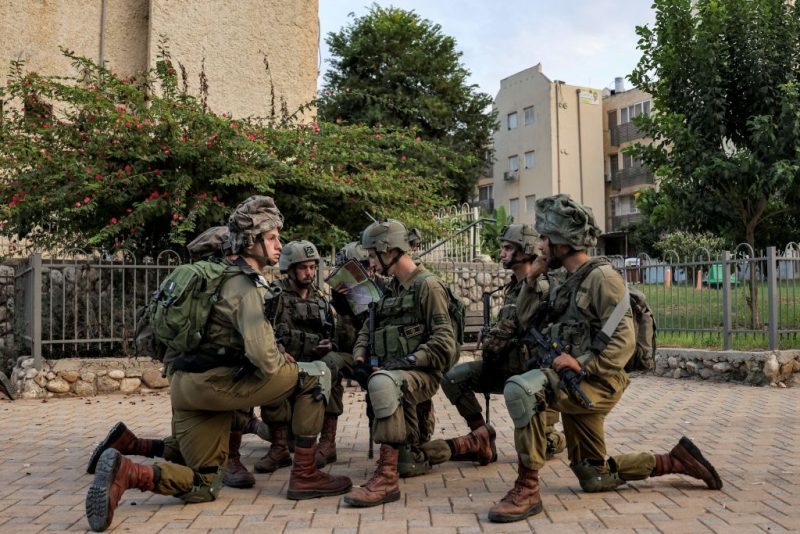 Israeli army soldiers deploy in the southern city of Sderot on October 8, 2023. The death toll surged to almost 1,000 since Palestinian militant group Hamas launched its massive surprise attack on Israel with a barrage of rockets and a massive ground assault, officials on both sides said on October 8. (Photo by Menahem KAHANA / AFP) (Photo by MENAHEM KAHANA/AFP via Getty Images)