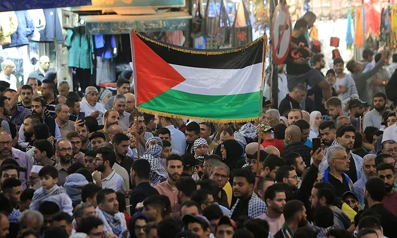 Jordanians wave the Palestinian flag as they gather to express their support for Gaza in Amman on October 10, 2023. In mosques, football stadiums and towns across the Arab world, pro-Palestinian sentiment has surged after a shock Hamas attack on Israel, sparking a groundswell of solidarity for the Palestinians. (Photo by AFP) (Photo by -/AFP via Getty Images)