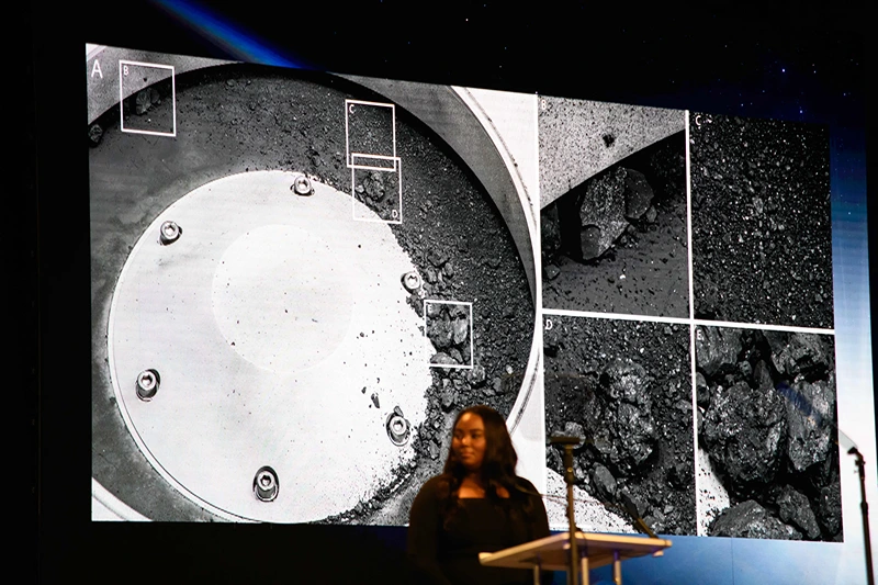 US-SPACE-ASTRONOMY-NASA
A picture of some of the sample matter collected from the asteroid is displayed during a press conference for the OSIRIS-REx sample unveiling at the Johnson Space Center in Houston, Texas on October 11, 2023. A sample collected from the 4.5-billion-year-old asteroid Bennu contains abundant water and carbon, NASA revealed on Wednesday, offering more evidence for the theory that life on Earth was seeded from outer space. (Photo by Mark Felix / AFP) (Photo by MARK FELIX/AFP /AFP via Getty Images)