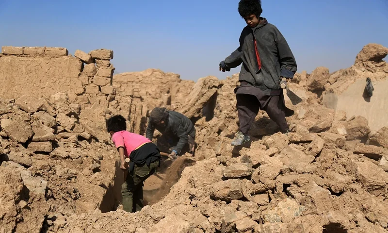 AFGHANISTAN-QUAKE Afghan residents clear the debris of houses that were damaged in a series of earthquakes, in Injil district of Herat province on October 15, 2023. A magnitude 6.3 earthquake killed two people in western Afghanistan on October 15, with damaged prisons emptied and residents fleeing a region where tremors have claimed at least 1,000 lives this past week. (Photo by Mohsen KARIMI / AFP) (Photo by MOHSEN KARIMI/AFP via Getty Images)