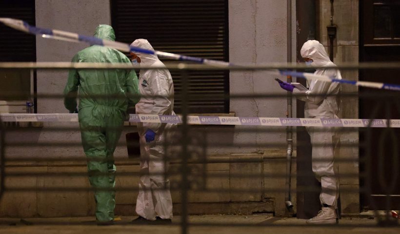 TOPSHOT - Belgian police officers from the forensic service search for evidence in a street after two people were killed during a shooting in Brussels on October 16, 2023 evening by a suspect who is on the run, the Belgian capital's prosecutor's office said. The alleged gunman in a fluorescent orange jacket fled the scene after using an automatic rifle, according to a video shared by Flemish newspaper Het Laatste Nieuws. A spokeswoman for the prosecutor's office said an investigation had been opened but did not speculate on the gunman's motive. (Photo by Kenzo TRIBOUILLARD / AFP) (Photo by KENZO TRIBOUILLARD/AFP via Getty Images)