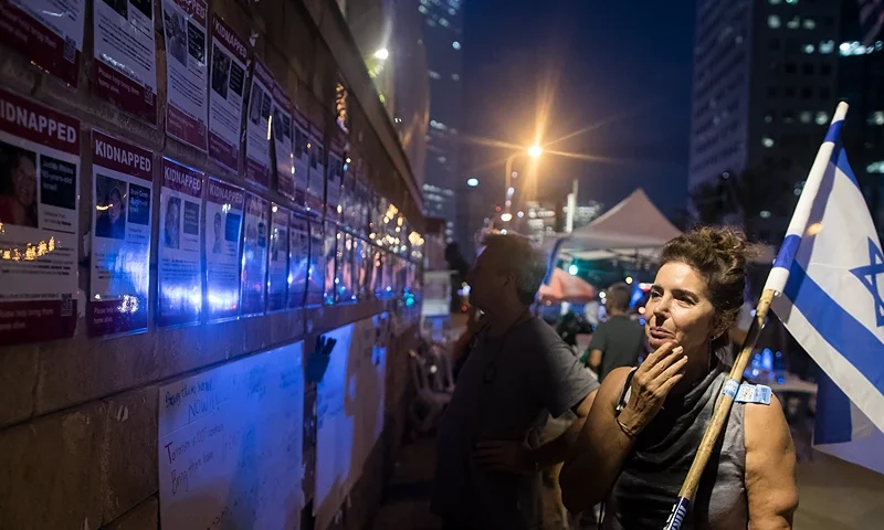 TEL AVIV, ISRAEL - OCTOBER 17: A woman looks at a wall with photos of hostages kidnapped and taken to Gaza in last Saturday's Hamas attack on October 17, 2023 in Tel Aviv, Israel. As Israel prepares to invade the Gaza Strip in its campaign to vanquish Hamas, the Palestinian militant group that launched a deadly attack in southern Israel on October 7th, worries are growing of a wider war with multiple fronts, including at the country's northern border with Lebanon. Countries have scrambled to evacuate their citizens from Israel, and Israel has begun relocating residents some communities on its northern border. Meanwhile, hundreds of thousands of residents of northern Gaza have fled to the southern part of the territory, following Israel's vow to launch a ground invasion. (Photo by Amir Levy/Getty Images)