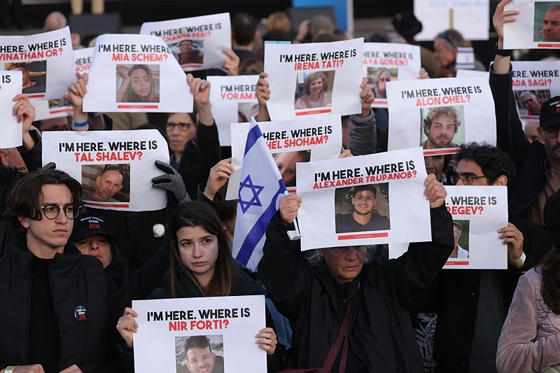 BERLIN, GERMANY - OCTOBER 22: People attending a demonstration to show solidarity with Israel and against anti-semitism hold up photographs of hostages taken by Hamas on October 22, 2023 in Berlin, Germany. Thousands of people attended the event in front of the Brandenburg Gate as the conflict between Hamas and Israel continues to range following the deadly October 7 incursions by Hamas fighters from Gaza into Israel. (Photo by Sean Gallup/Getty Images)