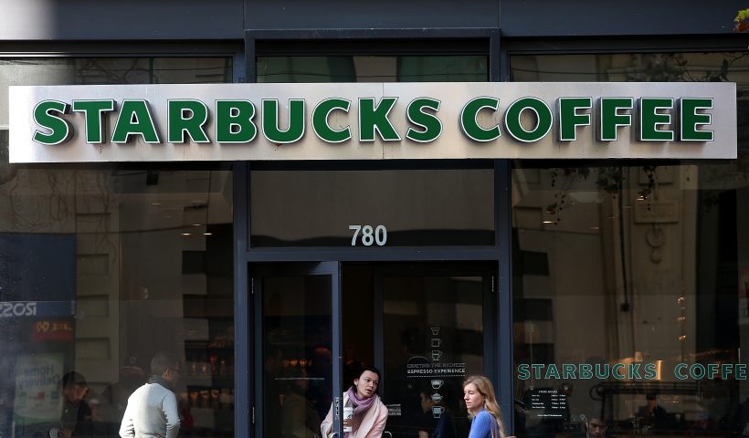 SAN FRANCISCO, CA - JANUARY 22: A Starbucks customer leaves a Starbucks Coffee shop on January 22, 2015 in San Francisco, California. Starbucks will report first quarter earnings January 22, after the close of the trading day. (Photo by Justin Sullivan/Getty Images)
