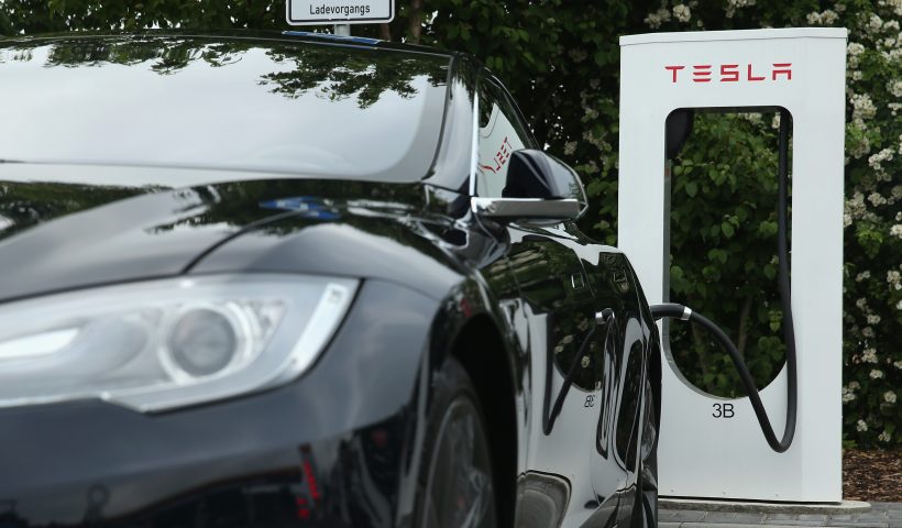 RIEDEN, GERMANY - JUNE 11: A Tesla electric-powered sedan stands at a Tesla charging staiton at a highway reststop along the A7 highway on June 11, 2015 near Rieden, Germany. Tesla has introduced a limited network of charging stations along the German highway grid in an effort to raise the viability for consumers to use the cars for longer journeys. (Photo by Sean Gallup/Getty Images)