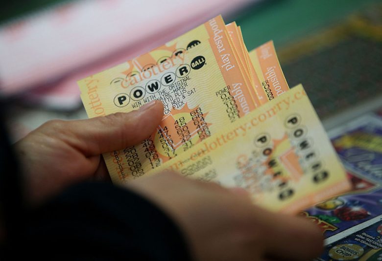 SAN LORENZO, CA - JANUARY 13: A customer buys Powerball tickets at Kavanagh Liquors on January 13, 2016 in San Lorenzo, California. Dozens of people lined up outside of Kavanagh Liquors, a store that has had several multi-million dollar winners, to -purchase Powerball tickets in hopes of winning the estimated record-breaking $1.5 billion dollar jackpot. (Photo by Justin Sullivan/Getty Images)