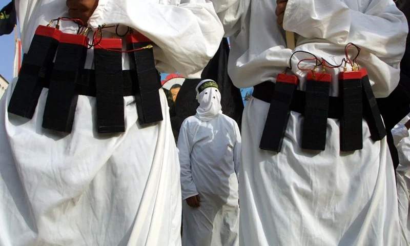 404380 01: Masked Islamic Jihad Militants Wear Explosive Belts During A Rally Commemorating Mohammed Irhaem And Saleh Hassouna April 23, 2002 In Gaza City, Gaza Strip. The Two Palestinian Men Were Shot And Killed On Friday, During An Exchange Of Fire With Israeli Troops Near The Jewish Settlement Of Netzarim In The Gaza Strip. Palestinians Have Accused Israeli Forces Of Committing A Massacre At The Jenin Camp, Described By Israel As A Bastion Of Terror. The Head Of The U.N. Agency For Palestinian Refugees Has Said That 800 Dwellings Were Destroyed And Many More Damaged In The Camp, Leaving 4,000 To 5,000 People Homeless.The Director Of The Local Hospital On Monday Put The Body Count At 45 And Stood By An Earlier Estimate That The Final Toll Might Be 300 Or 400. (Photo By Abid Katib/Getty Images)