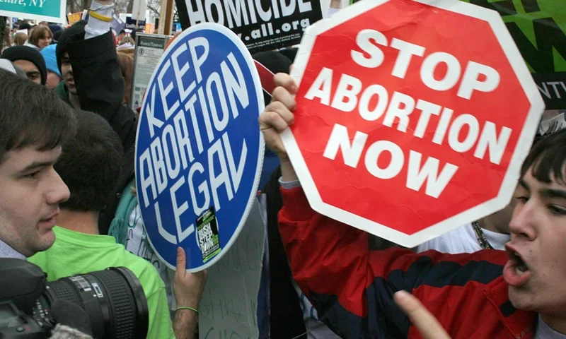 Pro-life demonstrators (R) confront pro- Washington, UNITED STATES: Pro-life demonstrators (R) confront pro-choice counterparts (L) 23 January 2006 in Washington, DC, as tens of thousands of pro-life and pro-choice opponents rally marking the 33rd anniversary of the Supreme Court ruling on abortion. Abortion has been legal in the United States since the Supreme Court's decision in Roe v. Wade on 22 January 1973. AFP PHOTO/Karen BLEIER (Photo credit should read KAREN BLEIER/AFP via Getty Images)