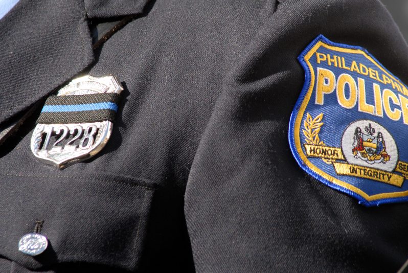 PHILADELPHIA - NOVEMBER 7: A Philadelphia Police officer wears a black ribbon on his badge at the funeral for Philadelphia Police Officer Chuck Cassidy November 7, 2007 at the Cathedral Basilica of Saints Peter and Paul in Philadelphia, Pennsylvania. Officer Cassidy was shot in the head allegedly by John "Jordan" Lewis as he robbed a Dunkin Donuts on October 31, 2007 in Philadelphia. Lewis was apprehended in Miami, Florida six days later. (Photo by William Thomas Cain/Getty Images)