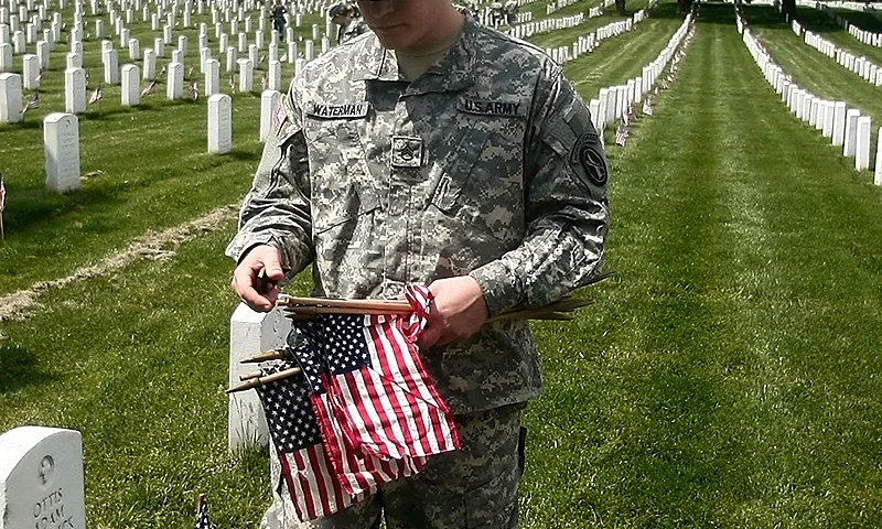 ARLINGTON, VA - MAY 22: U.S. Army soldiers place flags on gravesites during the Flags-In ceremony at Arlington National Cemetery May 22, 2008 in Arlington, Virginia. Over 1,300 soldiers place flags at each gravesite during the annual pre Memorial Day event to honor the veterans buried there. (Photo by Mark Wilson/Getty Images)