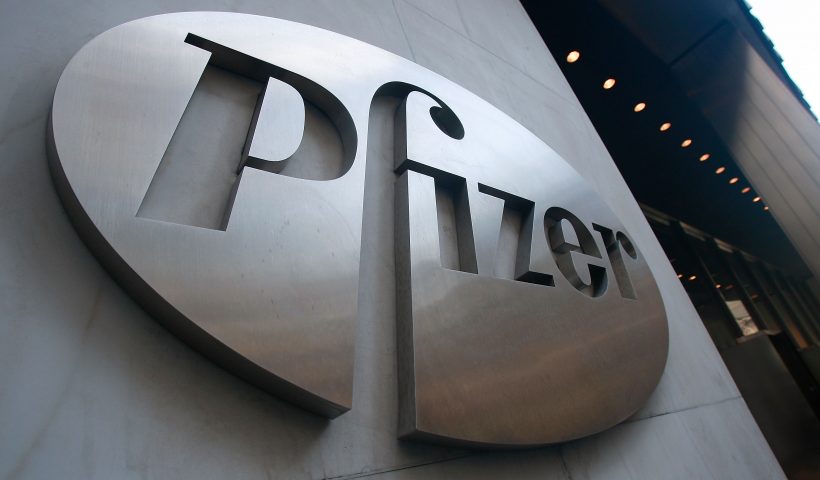 NEW YORK - JANUARY 26: A Pfizer sign hangs on the outside of their headquarters after a news conference discussing the planned merger of Pfizer and Wyeth January 26, 2009 in New York City. Pfizer plans to acquire Wyeth for $68 billion creating the world's largest biopharmaceutical company. (Photo by Mario Tama/Getty Images)