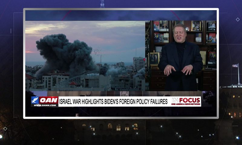 Video still from In Focus on One America News Network showing a split screen of the host on the left side, and on the right side is the guest, Wayne Allyn Root.
