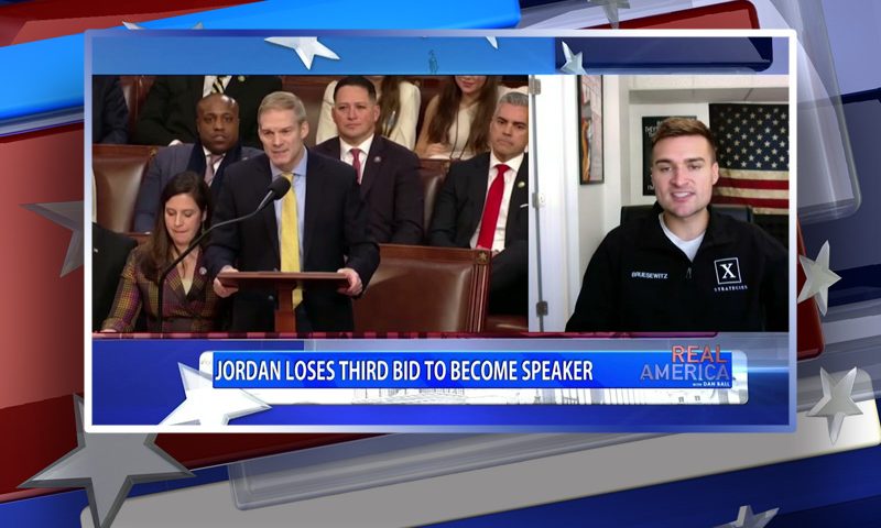 Video still from Real America on One America News Network during an interview with the guest, Alex Bruesewitz.