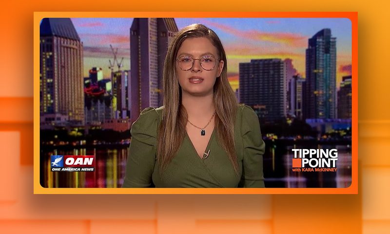 Video still of the host of Tipping Point at the desk of their talk show on One America News Network.