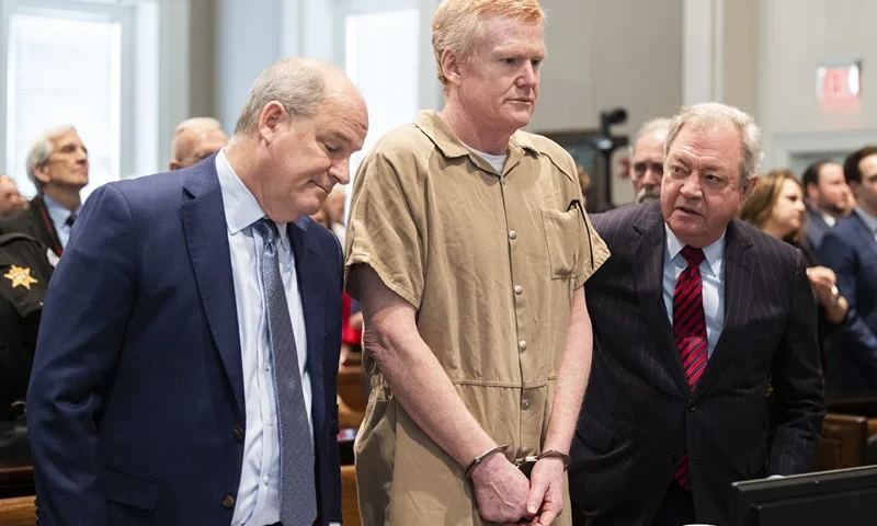 Alex Murdaugh speaks with his legal team before he is sentenced to two consecutive life sentences for the murder of his wife and son by Judge Clifton Newman at the Colleton County Courthouse on Friday, March 3, 2023 in in Walterboro, S.C. Murdaugh's lawyers have filed court papers that he plans to plead guilty in federal court to charges he stole money from clients. (Joshua Boucher/The State via AP, File, Pool)