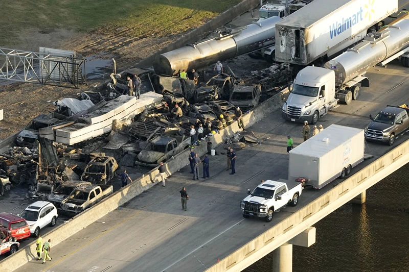 In this aerial photo, responders are seen near wreckage in the aftermath of a multi-vehicle pileup on I-55 in Manchac, La., Monday, Oct. 23, 2023. A "superfog" of smoke from south Louisiana marsh fires and dense morning fog caused multiple traffic crashes involving scores of cars. (AP Photo/Gerald Herbert)