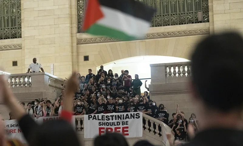 Protesters gather at Grand Central Terminal during a rally calling for a ceasefire between Israel and Hamas on Friday, Oct. 27, 2023, in New York. (AP Photo/Jeenah Moon)