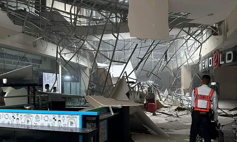 A security guard walks beside the damaged ceiling of a shopping mall in General Santos City, South Cotabato, southern Philippines on Friday Nov. 17, 2023. A powerful undersea earthquake has shaken the southern Philippines. The U.S. Geological Survey says the quake measured magnitude 6.7 and was located 26 kilometers (16 miles) from Burias at the southern tip of the Philippines. (AP Photo/Shaira Ann Sandigan)