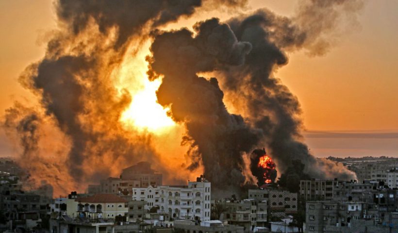 TOPSHOT - A fire rages at sunrise in Khan Yunish following an Israeli airstrike on targets in the southern Gaza strip, early on May 12, 2021. - Israeli air raids in the Gaza Strip have hit the homes of high-ranking members of the Hamas militant group, the military said Wednesday, with the territory's police headquarters also targeted. (Photo by YOUSSEF MASSOUD / AFP) (Photo by YOUSSEF MASSOUD/AFP via Getty Images)