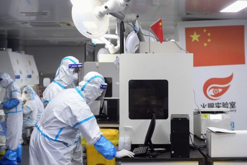 This photo taken on August 4, 2021 shows laboratory technicians wearing personal protective equipment (PPE) working on samples to be tested for the Covid-19 coronavirus at the Fire Eye laboratory, a Covid-19 testing facility, in Wuhan in China's central Hubei province. - China OUT (Photo by STR / AFP) / China OUT (Photo by STR/AFP via Getty Images)
