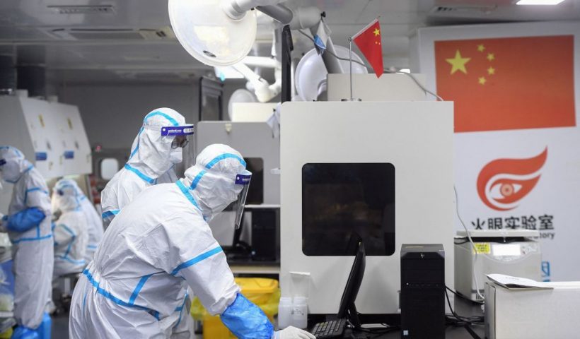 This photo taken on August 4, 2021 shows laboratory technicians wearing personal protective equipment (PPE) working on samples to be tested for the Covid-19 coronavirus at the Fire Eye laboratory, a Covid-19 testing facility, in Wuhan in China's central Hubei province. - China OUT (Photo by STR / AFP) / China OUT (Photo by STR/AFP via Getty Images)