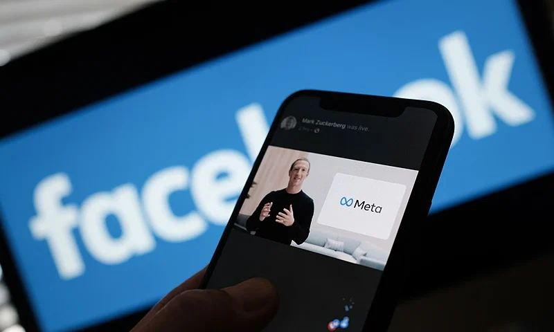 In this illustration photo taken in Los Angeles on October 28, 2021, a person watches on a smartphone Facebook CEO Mark Zuckerberg unveil the META logo. - Facebook chief Mark Zuckerberg on Thursday announced the parent company's name is being changed to "Meta" to represent a future beyond just its troubled social network. The new handle comes as the social media giant tries to fend off one its worst crises yet and pivot to its ambitions for the "metaverse" virtual reality version of the internet that the tech giant sees as the future. (Photo by Chris DELMAS / AFP) (Photo by CHRIS DELMAS/AFP via Getty Images)