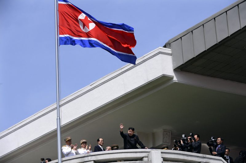 TOPSHOT - North Korea's leader Kim Jong-Un (C) waves at the end of a major military parade to mark 100 years since the birth of the country's founder and his grandfather, Kim Il-Sung, in Pyongyang on April 15, 2012. The commemorations came just two days after a satellite launch timed to mark the centenary fizzled out embarrassingly when the rocket apparently exploded within minutes of blastoff and plunged into the sea. AFP PHOTO / PEDRO UGARTE (Photo by Pedro UGARTE / AFP) (Photo by PEDRO UGARTE/AFP via Getty Images)