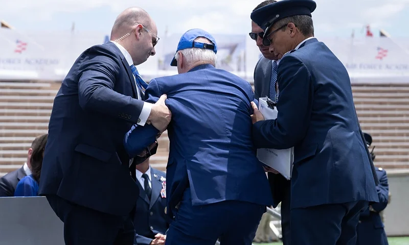 US President Joe Biden is helped up after falling during the graduation ceremony at the United States Air Force Academy, just north of Colorado Springs in El Paso County, Colorado, on June 1, 2023. (Photo by Brendan Smialowski / AFP) (Photo by BRENDAN SMIALOWSKI/AFP via Getty Images)
