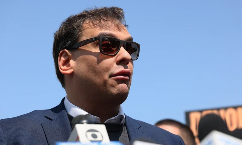CENTRAL ISLIP, NEW YORK - MAY 10: Rep. George Santos (R-NY) speaks with members of the press as he leaves Federal Court on May 10, 2023 in Central Islip, New York. Federal prosecutors in the Eastern District of New York have charged Santos in a 13-count indictment that includes seven counts of wire fraud, three counts of money laundering, one count of theft of public funds, and two counts of making materially false statements to the House of Representatives. The Republican congressman, who represents communities on Long Island and in Queens, has lied about his professional accomplishments, his education and his family's history, statements which surfaced after he was elected last year. He has admitted to embellishing his resume but denies any criminal wrongdoing. (Photo by Michael M. Santiago/Getty Images)