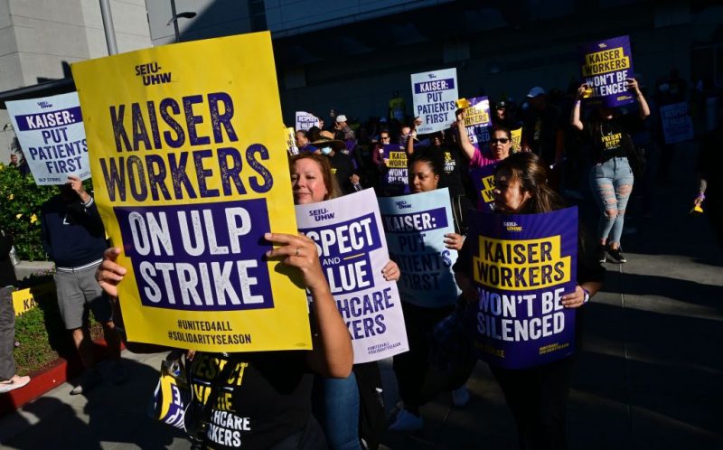 Kaiser Permanente employees, joined by Union members representing the workers, walk the picket line in Los Angeles, California on October 4, 2023. More than 75,000 employees at Kaiser Permanente began one of the largest healthcare worker strikes in recent US history on Wednesday after failing to resolve a dispute over staffing levels. (Photo by Frederic J. BROWN / AFP) (Photo by FREDERIC J. BROWN/AFP via Getty Images)