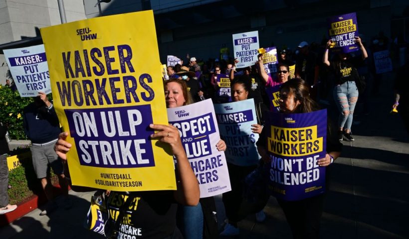 Kaiser Permanente employees, joined by Union members representing the workers, walk the picket line in Los Angeles, California on October 4, 2023. More than 75,000 employees at Kaiser Permanente began one of the largest healthcare worker strikes in recent US history on Wednesday after failing to resolve a dispute over staffing levels. (Photo by Frederic J. BROWN / AFP) (Photo by FREDERIC J. BROWN/AFP via Getty Images)