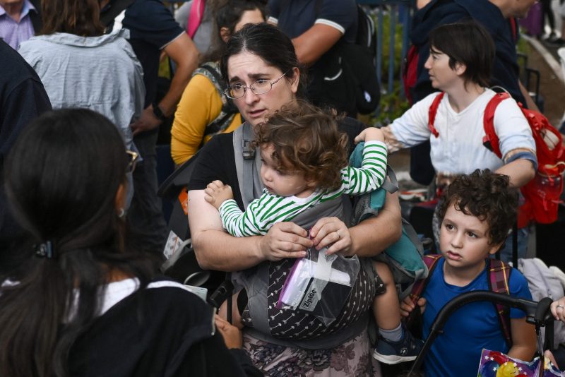 TOPSHOT - US citizens wait at the port of Haifa to be evacuated to Cyprus on October 16, 2023, amid the ongoing battles between Israel and the Palestinian Islamist group Hamas. Israel declared war on Hamas a day after waves of its fighters broke through the heavily fortified border on October 7, shooting, stabbing and burning to death more than 1,400 people, most of them civilians. Israel then unleashed a relentless bombing campaign of Gaza that has flattened neighbourhoods and left at least 2,670 people dead in the territory, mainly civilians. (Photo by Aris MESSINIS / AFP) (Photo by ARIS MESSINIS/AFP via Getty Images)