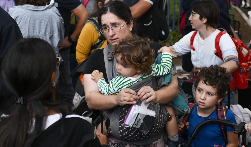 TOPSHOT - US citizens wait at the port of Haifa to be evacuated to Cyprus on October 16, 2023, amid the ongoing battles between Israel and the Palestinian Islamist group Hamas. Israel declared war on Hamas a day after waves of its fighters broke through the heavily fortified border on October 7, shooting, stabbing and burning to death more than 1,400 people, most of them civilians. Israel then unleashed a relentless bombing campaign of Gaza that has flattened neighbourhoods and left at least 2,670 people dead in the territory, mainly civilians. (Photo by Aris MESSINIS / AFP) (Photo by ARIS MESSINIS/AFP via Getty Images)