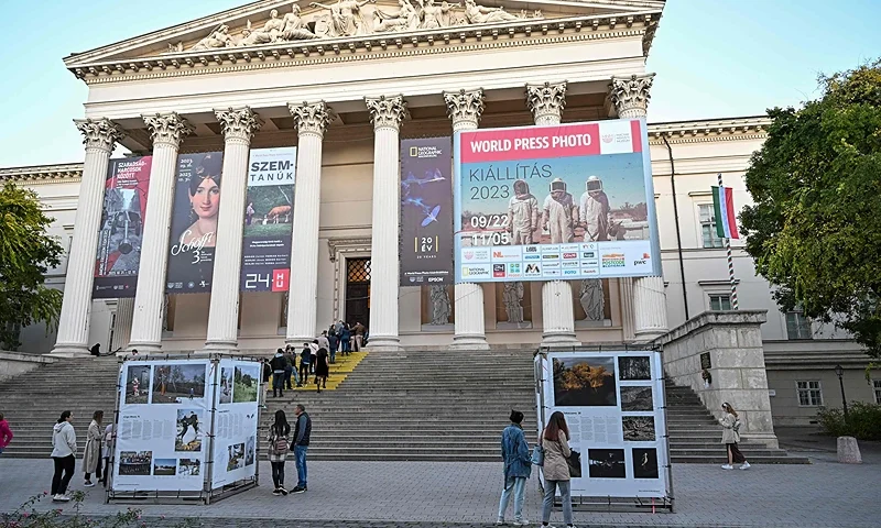 People wait in the queue to visit the exhibition of the World Press Photo at the Hungarian National Museum in Budapest on November 1, 2023. Hungary's National Museum said on November 1, 2023 that it cannot legally enforce a government order, barring minors from the World Press Photo exhibition under a controversial law targeting LGBTQ content. The exhibition -- a showcase of the annual competition that awards "the best visual journalism" around the world -- started in September and runs until November 5 at the National Museum in Budapest. (Photo by ATTILA KISBENEDEK / AFP) (Photo by ATTILA KISBENEDEK/AFP via Getty Images)
