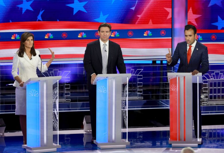 MIAMI, FLORIDA - NOVEMBER 08: Republican presidential candidate former U.N. Ambassador Nikki Haley puts her hand up to Vivek Ramaswamy while he speaks to her as Florida Gov. Ron DeSantis (C) listens during the NBC News Republican Presidential Primary Debate at the Adrienne Arsht Center for the Performing Arts of Miami-Dade County on November 8, 2023 in Miami, Florida. Five presidential hopefuls squared off in the third Republican primary debate as former U.S. President Donald Trump, currently facing indictments in four locations, declined again to participate. (Photo by Joe Raedle/Getty Images)