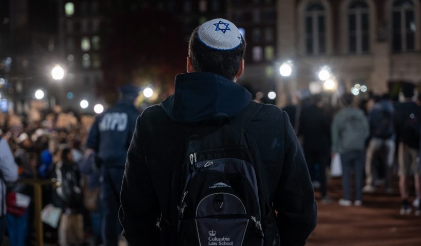 NEW YORK, NEW YORK - NOVEMBER 14: A Jewish student watches a protest in support of Palestine and for free speech at Columbia University campus on November 14, 2023 in New York City. The university suspended two student organizations, Students for Justice in Palestine, and Jewish Voices for Peace, for violating what was called university policies. The tense atmosphere at many college campuses has increased as student groups, activists and others have protested both in support of Israel and of Palestine. (Photo by Spencer Platt/Getty Images)