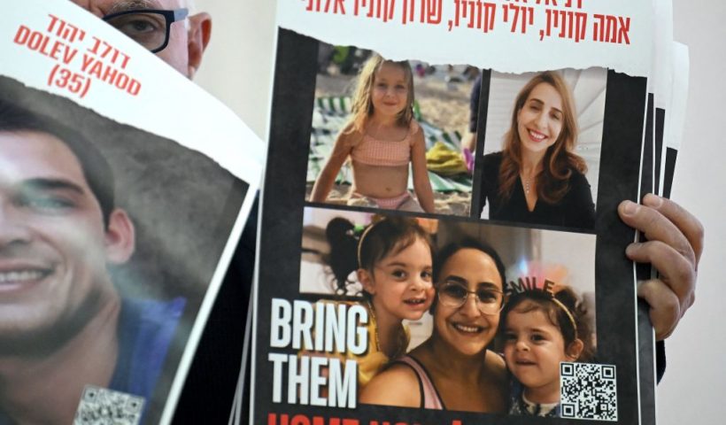 Family member of hostages held by Palestinian militant group Hamas in Gaza, holding a portrait of his relatives at the Italian Jewish Center, during a press conference after having a meeting with Pope Francis at The Vatican, in Rome, on November 22, 2023. (Photo by Filippo MONTEFORTE / AFP) (Photo by FILIPPO MONTEFORTE/AFP via Getty Images)