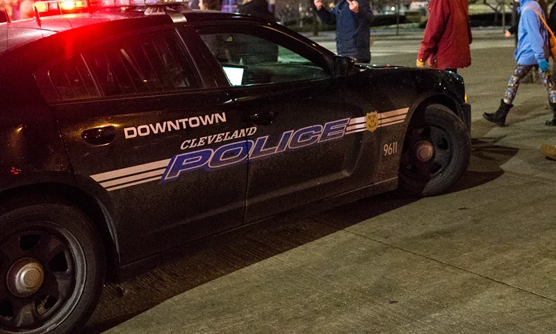 Protestors From Ferguson Join Cleveland Activists For Rallies Against Tamir Rice Shooting CLEVELAND, OH - DECEMBER 21: Demonstrators march past a police cruiser on S. Roadway outside of Public Square December 21, 2014, in Cleveland, Ohio. Protestors gathered for the second straight day voicing opposition to the shooting death of 12-year old Tamir Rice. (Photo by Angelo Merendino/Getty Images)